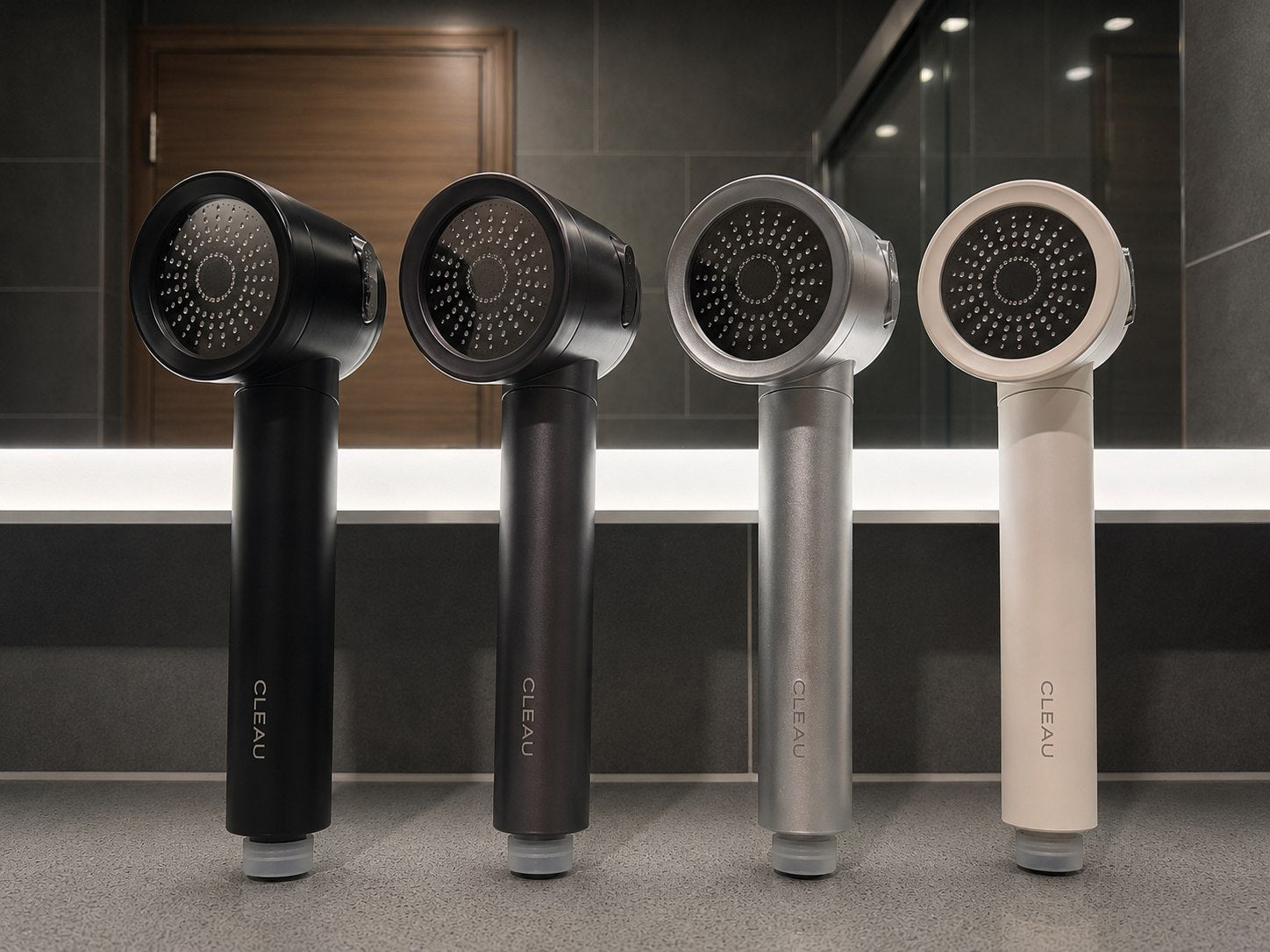 The CLEAU shower head shown in all four finishes — Matte Black, Graphite, Space Grey and White