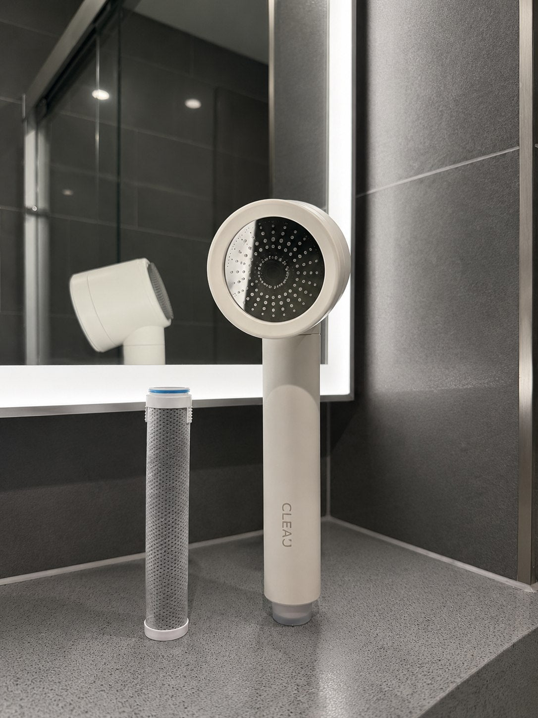 Close view of the CLEAU shower head in matte white, showing the finish and build quality