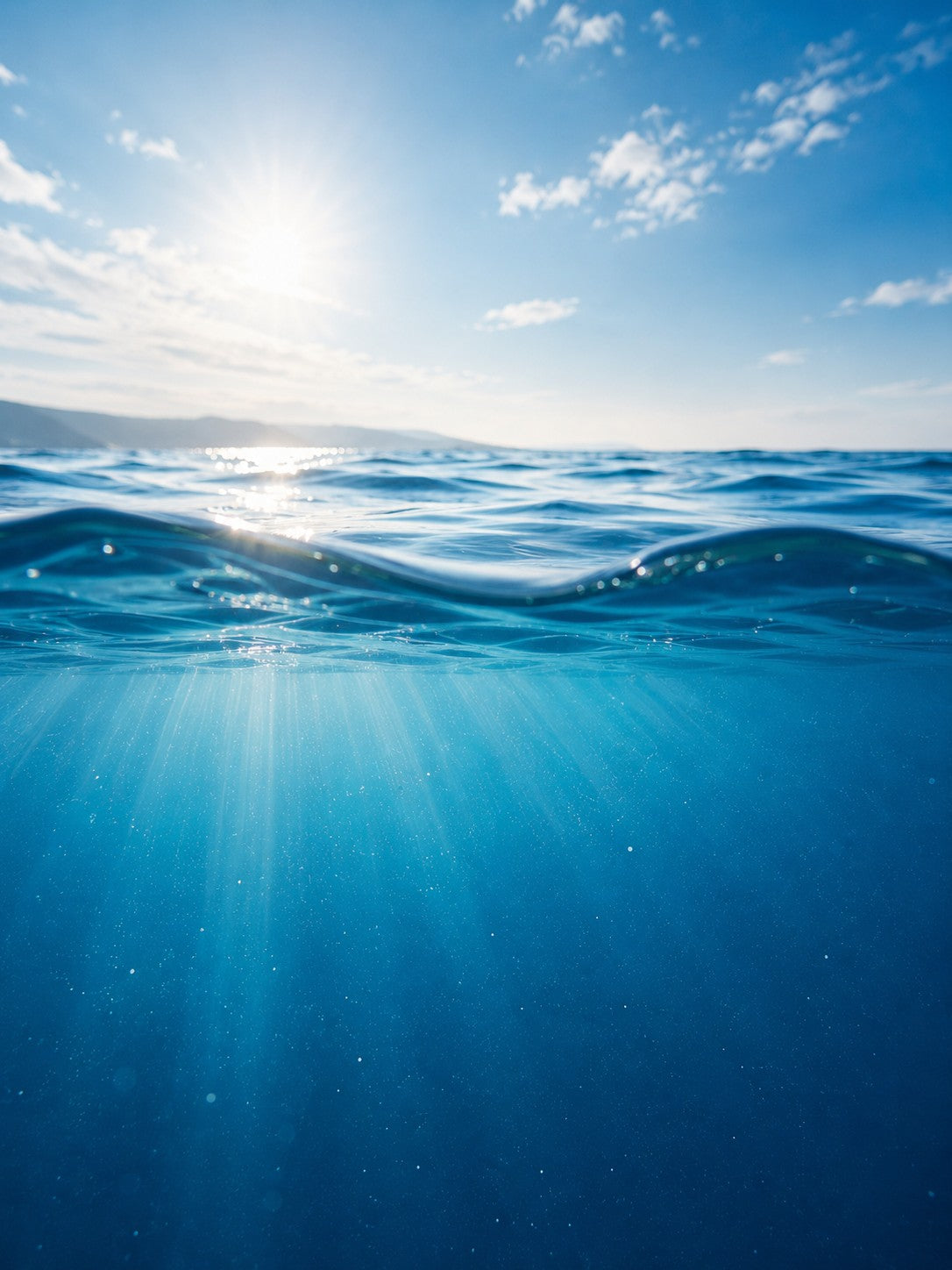Sunlit ocean water, representing the journey water takes before it reaches your home